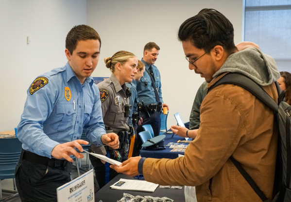 student and police officer talking